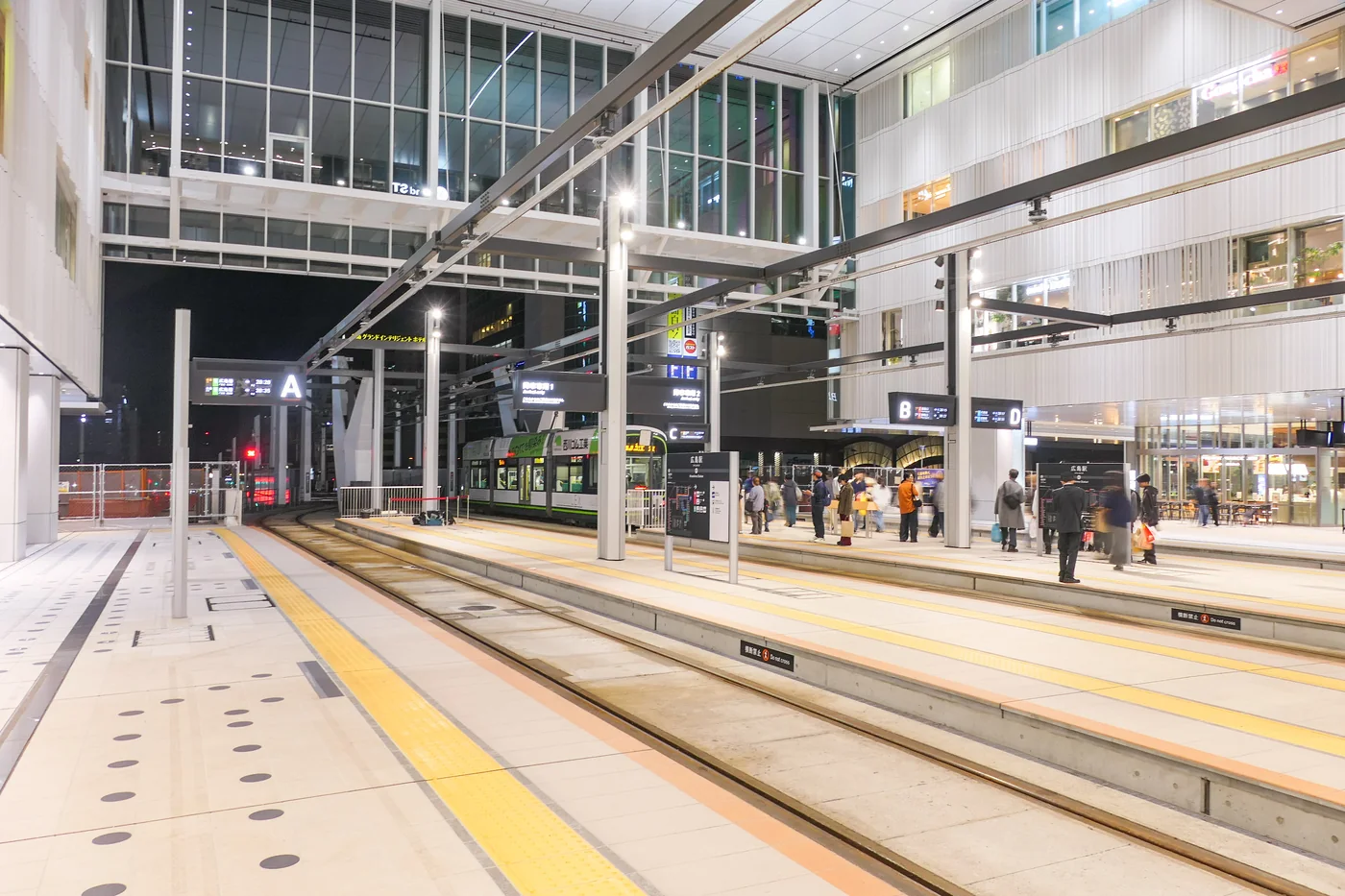 廣電廣島站二樓乘車區,軌道、月台與大樓內部在同一畫面